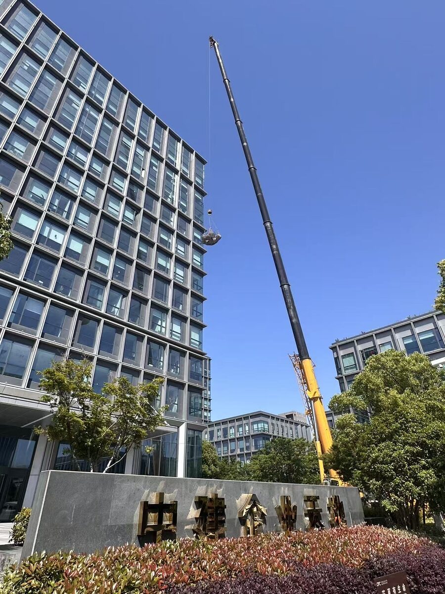 China Construction Enterprise Plaza sign with a crane lifting panels
